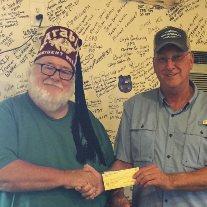 Carmine Lion President, Ricky Weyand, right, presented two donations totaling $1,000 to Mike Thorpe, President of the Brenham Shrine Club recently.