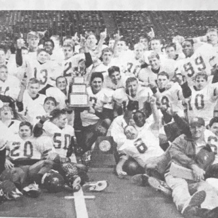 The members of the 2000 La Grange football team pose on the field at Texas Stadium in Irving after their championship game win.