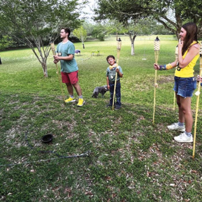 The final four contestants on Survivor 26: Panorama stand with their tiki torches – left to right: host Allegra Berckmoes, Matt Berckmoes, Liam Strong, Ella Wick and Winnie Schielack.