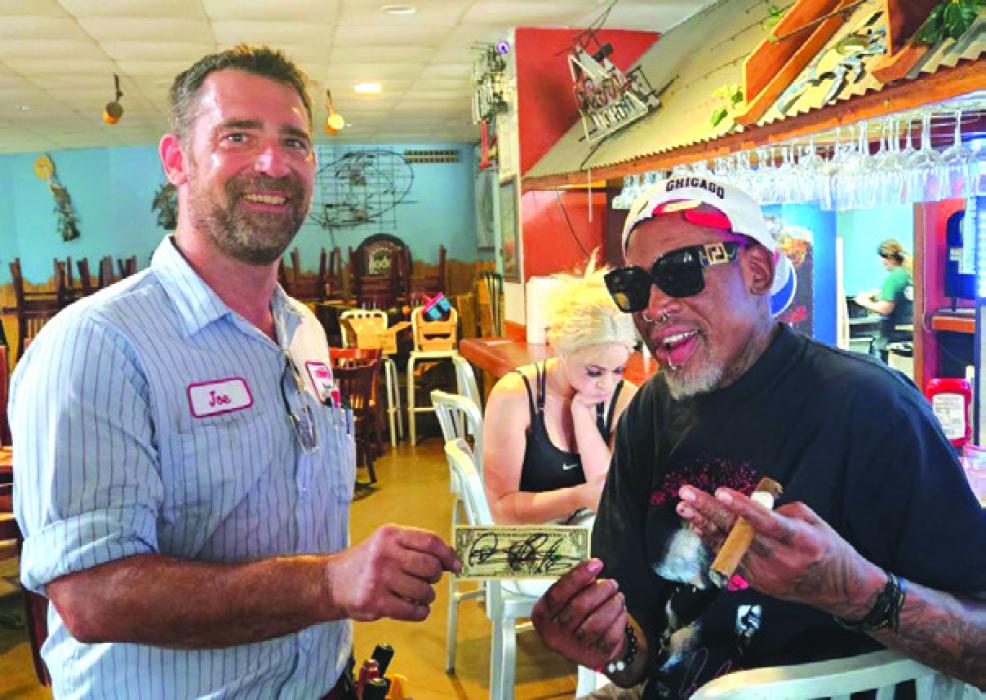 Retired basketball star and five-time NBA champion Dennis Rodman stopped in La Grange on Tuesday to eat at Sealand Restaurant. Joe Gilliam of Reeder’s A/C and Heat happened to be at the restaurant to work on the building’s air conditioning at the time. Gilliam is pictured above with the famously eccentric athlete and a dollar bill that Rodman signed for him.