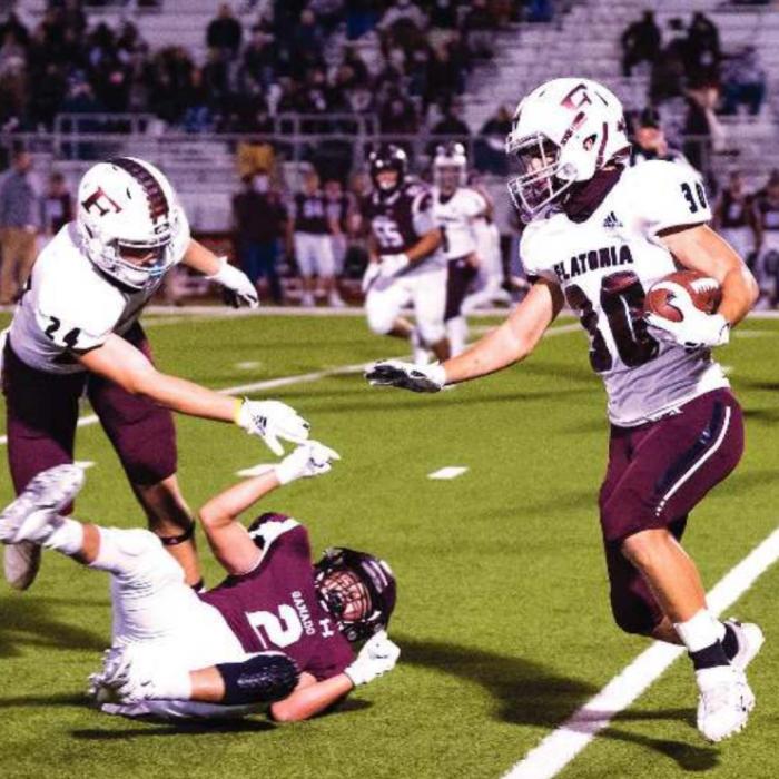 Holden Kloesel stops a Ganado Indian from stopping Chris Johnston from picking up yardage for the Bulldogs. Photo by Stephanie Steinhauser