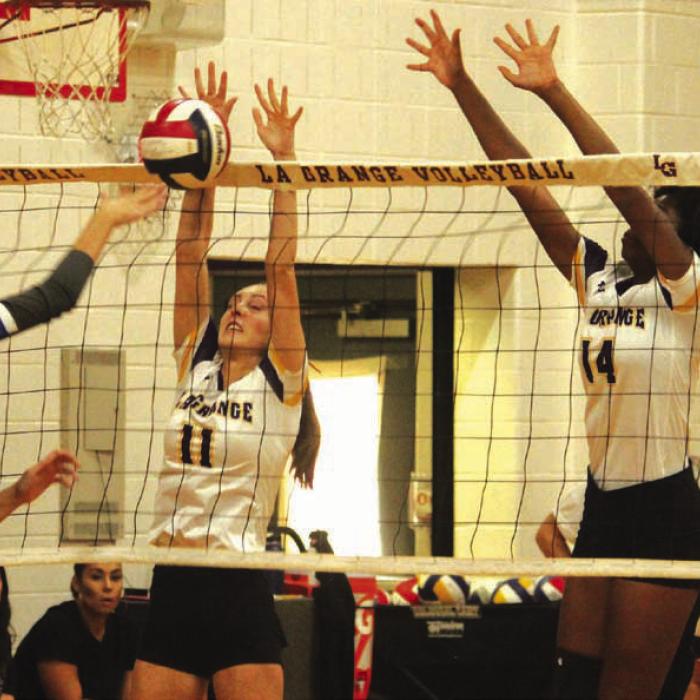 La Grange’s Lyndie Edson, center, and Tori Harold, right, block this try by Manor New Tech in Friday’s match.