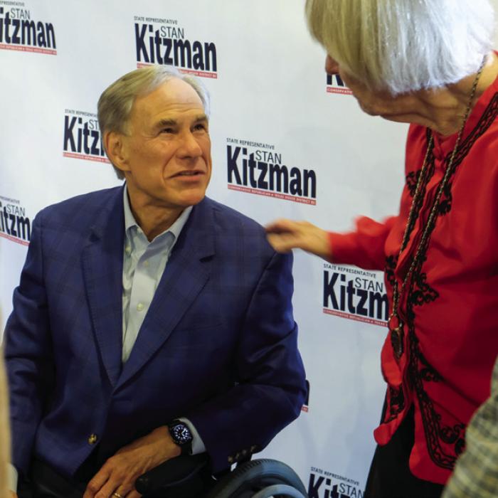 Texas Governor Greg Abbott speaks with a voter after delivering his remarks on Thursday. Photo by Andy Behlen