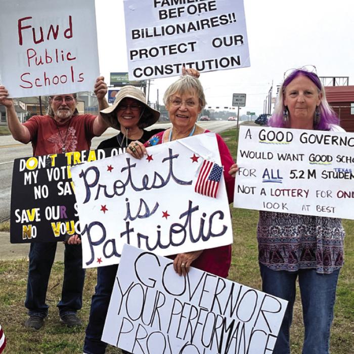 Several folks stood alongside Business 71 outside Jay Dee’z with signs during Greg Abbott’s visit to La Grange, stating complaints about the governor’s performance. Photo courtesy of Virginia Leech