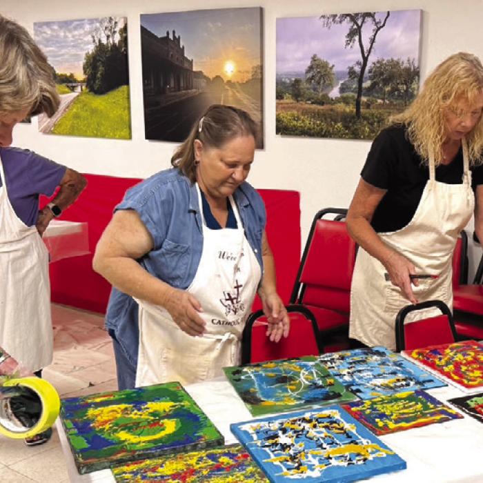 Delores Bitner, Sharon Friedrich and Jody Driskell are pictured here making room for more modern art pieces they were creating in Jaime Janda’s Painting Without Brushes class. This class got students out of their comfort zone.