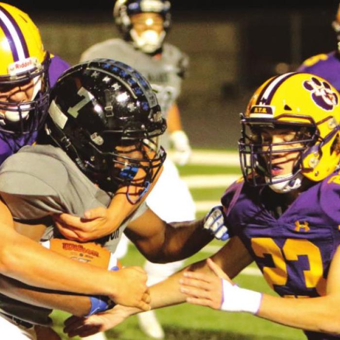 La Grange’s Grant Hollek (No. 74) and Jeremy Sager (No. 23) converge to make this tackle Thursday. Photo by Darrell D. Gest