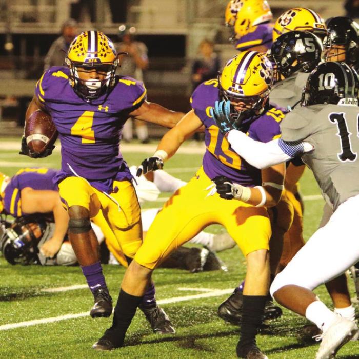 La Grange’s Dana Baker runs behind the block of teammate Kadyn Hall Thursday. Photo by Darrell D. Gest