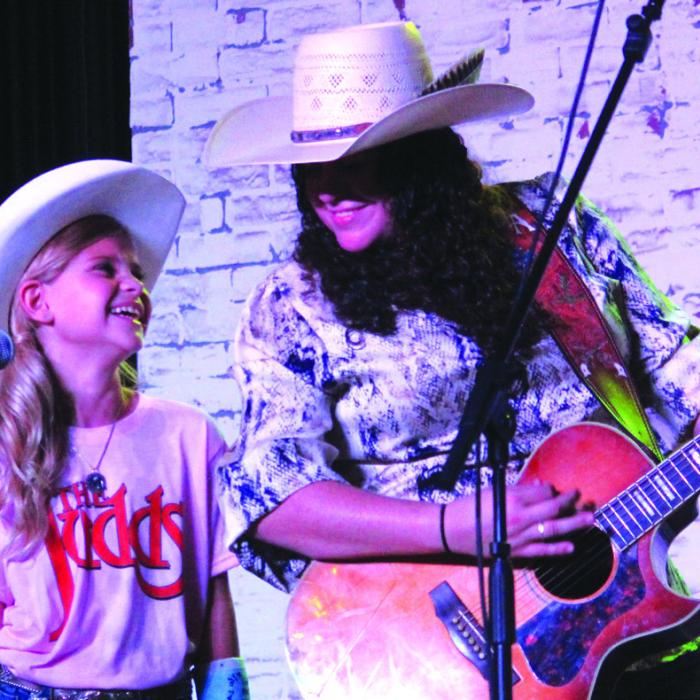 While this year’s Fayette County Fair had musical headliners from all over the country, one of the loudest crowds of the four day fair was for a pair of local performers, Marley Jane Vasek, left, and Briana Adams, who sang several songs during Thursday’s Queen’s contest. Photo by Jeff Wick