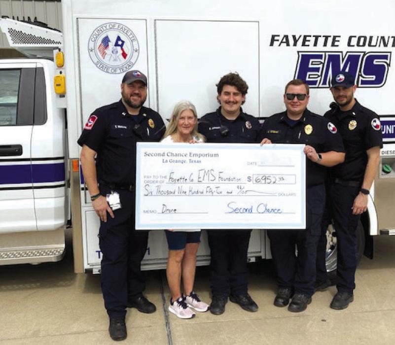 Second Chance Emporium (SCE) recently donated $6,952.95 to the Fayette County EMS (FCEMS) Foundation. A drone will be purchased with the monies donated and will be used by the volunteer fire departments in Fayette County to search for heat/fire and to help locate lost individuals. Pictured from left to right: Neil Watkins, FCEMS Captain; Gayle Schielack, SCE Store Director; Brandon Johnson, FCEMS Foundation President; Josh Vandever, FCEMS Director; and Justin Leslie, FCEMS Lieutenant.