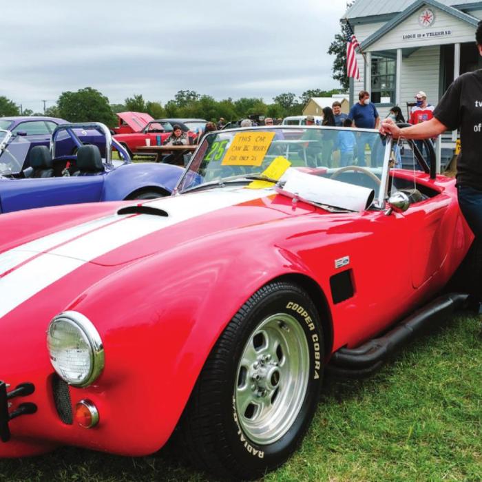 Theresa Brown, executive director of the Gardenia E. Janssen Animal Shelter poses next to this replica 1966 Shelby Cobra at the Heritage Fest Car Show. The Cobra will be given away in a fundraiser drawing benefiting the Animal Shelter. The classic car was graciously donated by John and Betty Burkland. Tickets for the drawing are $25. They can be purchased online at janssenanimalshelter. org. Deadline to enter is Dec. 31. The drawing will take place Jan. 4.