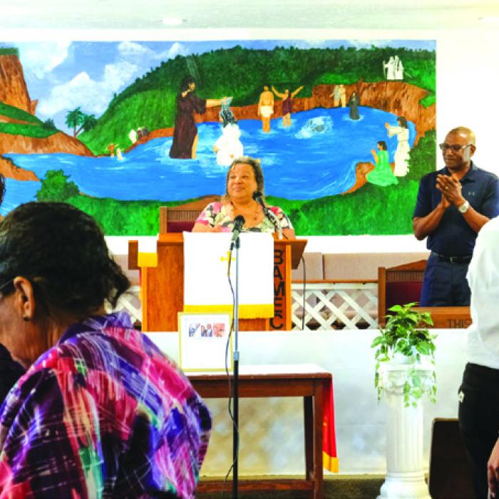 The wall behind the pulpit at Bethlehem AME features a mural depicting John the Baptist baptizing Jesus in the Jordan River.