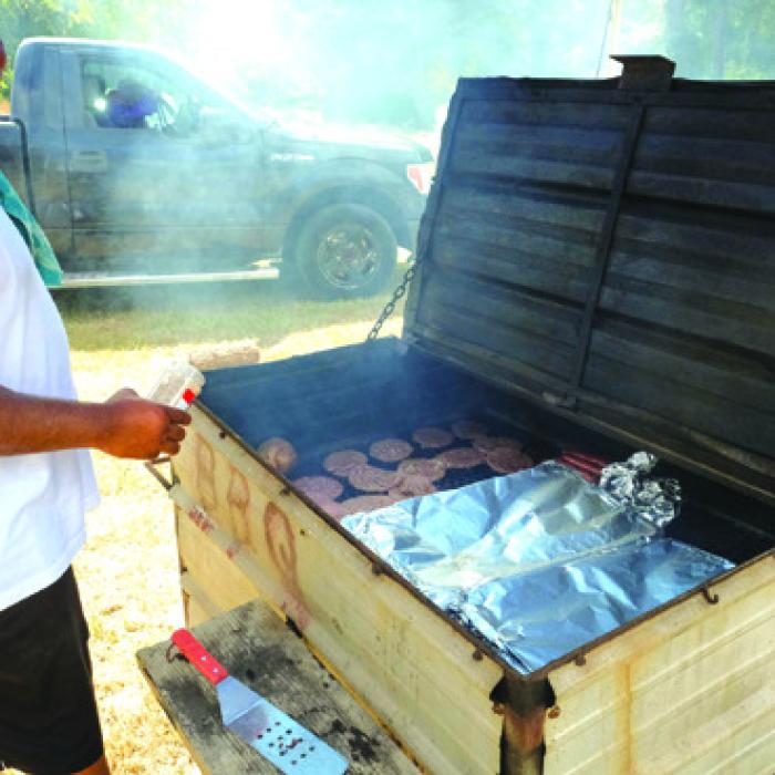 Walter Culberson grilled hamburgers and hot dogs for the congregation last Saturday afternoon.