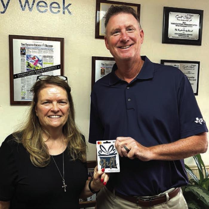 David Cooper of La Grange was the first $100 winner in our Fayette County Record reader Football Pick-It contest of the year after picking all 10 games correctly. He is shown here accepting the $100 gift card from publisher Regina Keilers, left. The ballot appears in the Record every Tuesday during the season.