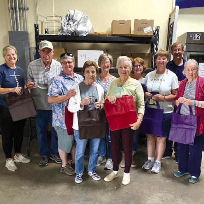 Members representing Holy Rosary Catholic Church in Hostyn &amp; Sts. Peter &amp; Paul Catholic Church in Plum donated 76 reusable bags to AMEN.