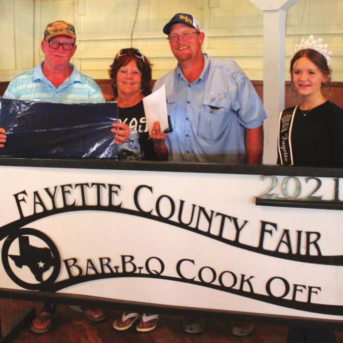 The Champion brisket at this year’s Fayette County Fair was made by S&amp;V Cookers of West Point, which included Steve McCarthy, Vickie McCarty and Daryl McCarty. Also shown is Fayette County Fair Queen Charlee Wessels.