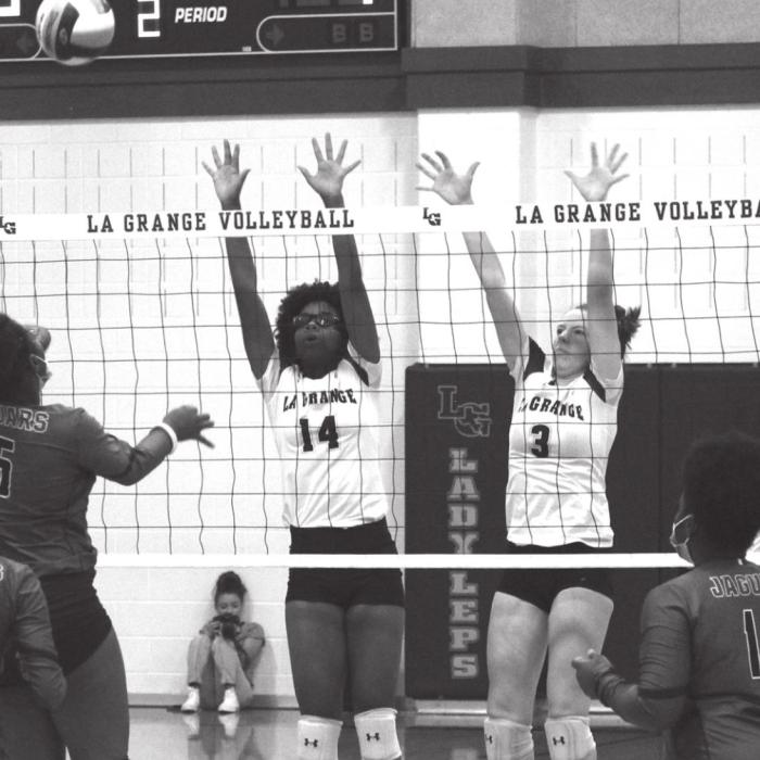 La Grange’s Tori Harold and Hailey Hill jump at the net in action last week at home against Austin LBJ. The Lady Leps won Tuesday against Austin Eastside and play Friday at first place Giddings. Photo by Jeff Wick