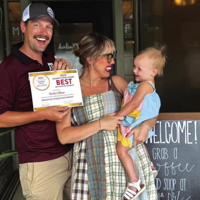 Taylor Swenning, her husband Chris and one of their two daughters.