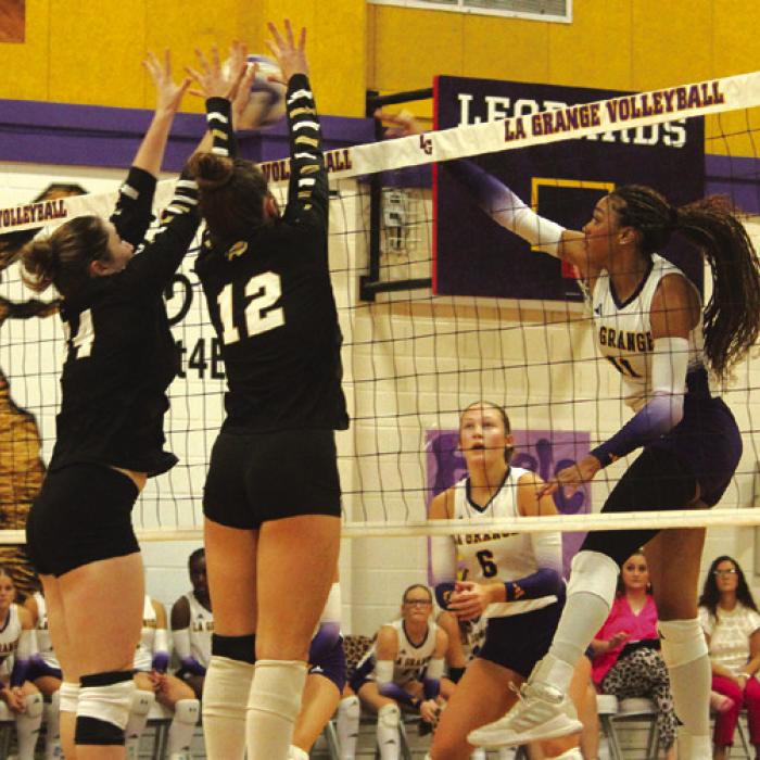 La Grange’s Brion Williams smashes a shot past a pair of Giddings blockers during Friday’s match. Photo by Jeff Wick