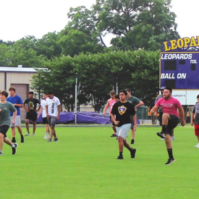 La Grange high school football players go through stretching drills Tuesday morning at Leopard Stadium. Photo by Jeff Wick
