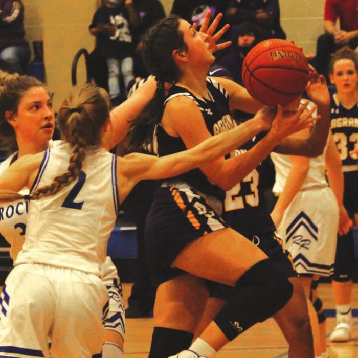 Sophomore Keslyn Davis drives between a pair of defenders. Photo by Jeff Wick