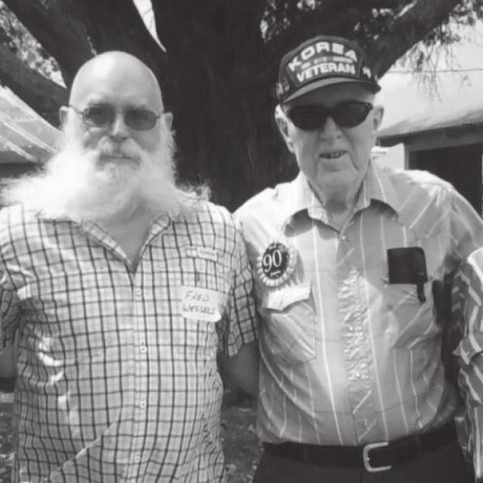 Gene (third from left) is joined by members of his family who also have served or are currently serving their country. From left to right are: great-grandson Hayden, son Fred and son Gary.
