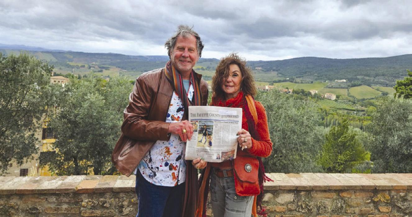 Gary and Carol Bucek with the Polka Lovers Club of Texas Museum in La Grange recently traveled to San Gimignano, Italy. They are pictured here with their copy of the Fayette County Record.