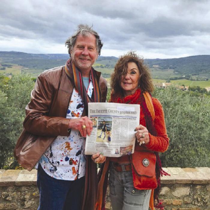 Gary and Carol Bucek with the Polka Lovers Club of Texas Museum in La Grange recently traveled to San Gimignano, Italy. They are pictured here with their copy of the Fayette County Record.