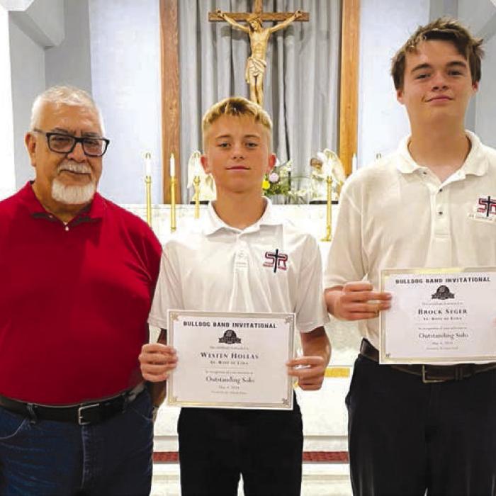 Outstanding Solo pictured from left: Band Director Julius Castillo, Weston Hollasm, and Brock Seger.