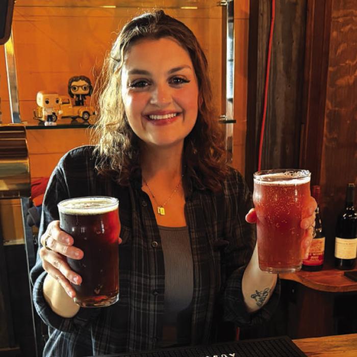 Lyxie Hrbacek serves us a couple of their specialty beers at Round Top Brewing. Photo by Andy Behlen