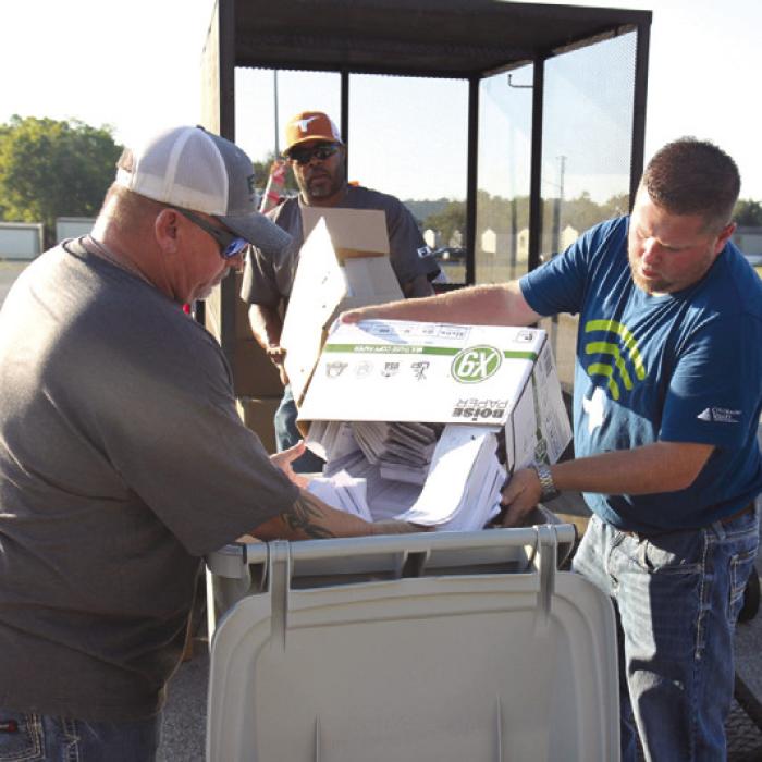 FEC employees Tiger Hall and Macy Scott (left and center) joined CVTC’s Clint Ruckman (right) in preparing documents to be shredded at last year’s event.