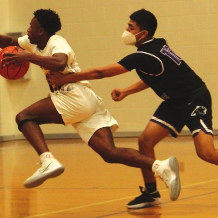 La Grange’s Dana Baker drives past a Austin player on his way to the basket Tuesday. Photo by Jeff Wick