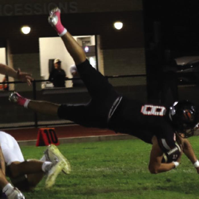 Schulenburg’s Owen Brenek dives forward for yardage Friday. Photo by Audrey Kristynik