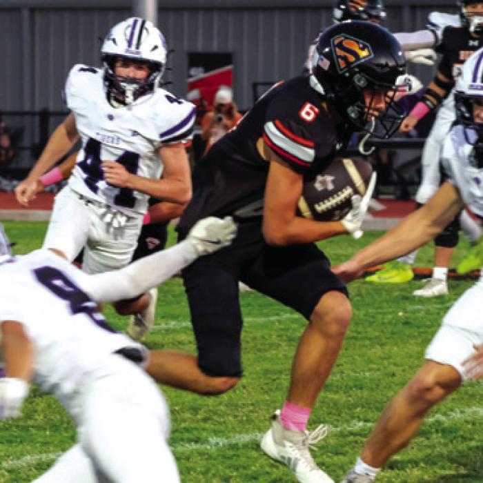 Shorthorn freshman receiver Cal Schiffli hurdles his way to a first down Friday. Photo by Andy Behlen