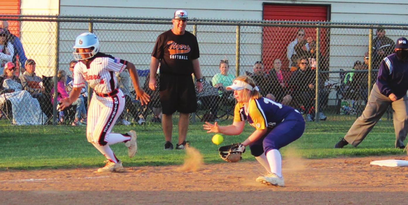 La Grange third baseman Avery Marshall fields a sharply-hit grounder as Smithville’s Mihyia Davis breaks for home with the bases loaded Tuesday. Marshall would throw Davis out at the plate. Photo by Jeff Wick
