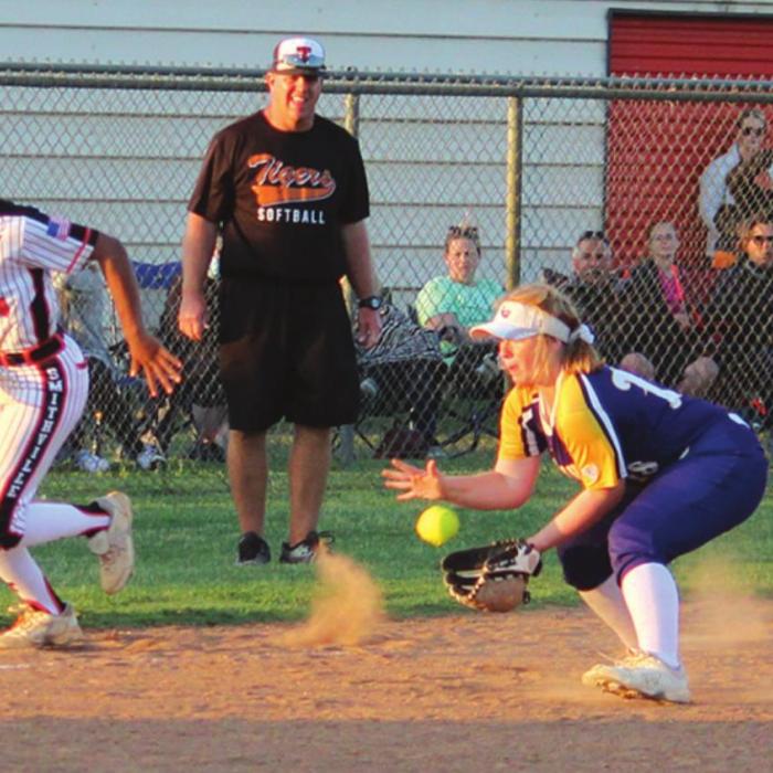 La Grange third baseman Avery Marshall fields a sharply-hit grounder as Smithville’s Mihyia Davis breaks for home with the bases loaded Tuesday. Marshall would throw Davis out at the plate. Photo by Jeff Wick