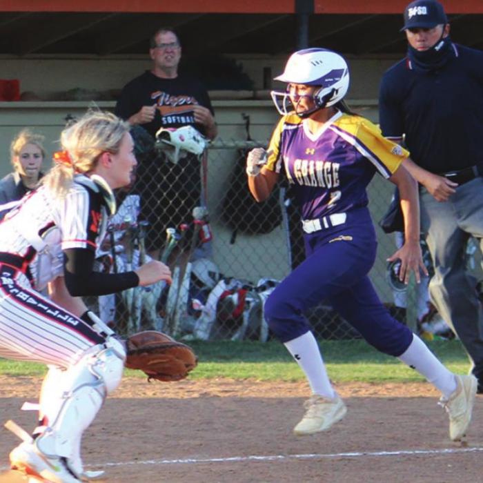 Left: La Grange’s Alyssa Dela Rosa comes home to score early in the game Tuesday.