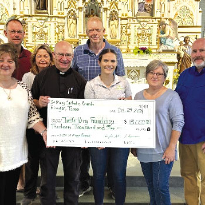 Destiny Siptak, Turtle Wing Foundation Executive Director, accepted the donation from St. Mary Catholic Church.