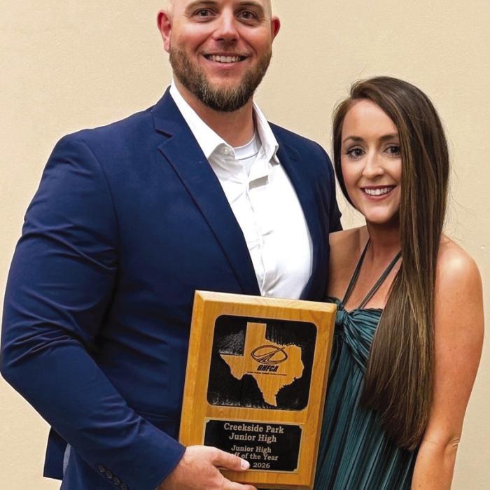 Matthew Miori and his wife Rachel with his award from the Greater Houston Football Coaches Association.