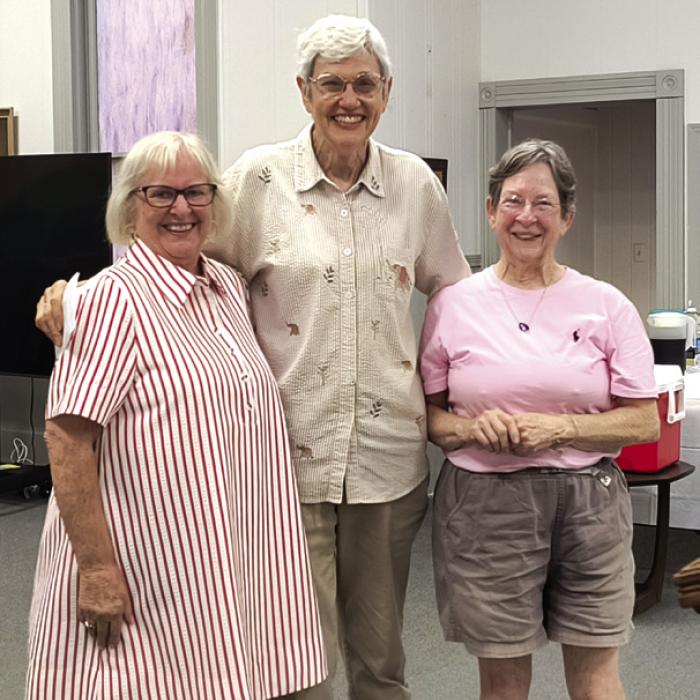 Susan Schultz, middle, and Mary Lou McElroy, right, from the AMEN Food Pantry In La Grange are pictured with Leonita Sanders, left, president of MLLC WELCA. They were presented with 231 pounds of food and a $1,250 monetary donation for the food pantry at the WELCA Salad Supper in Carmine.
