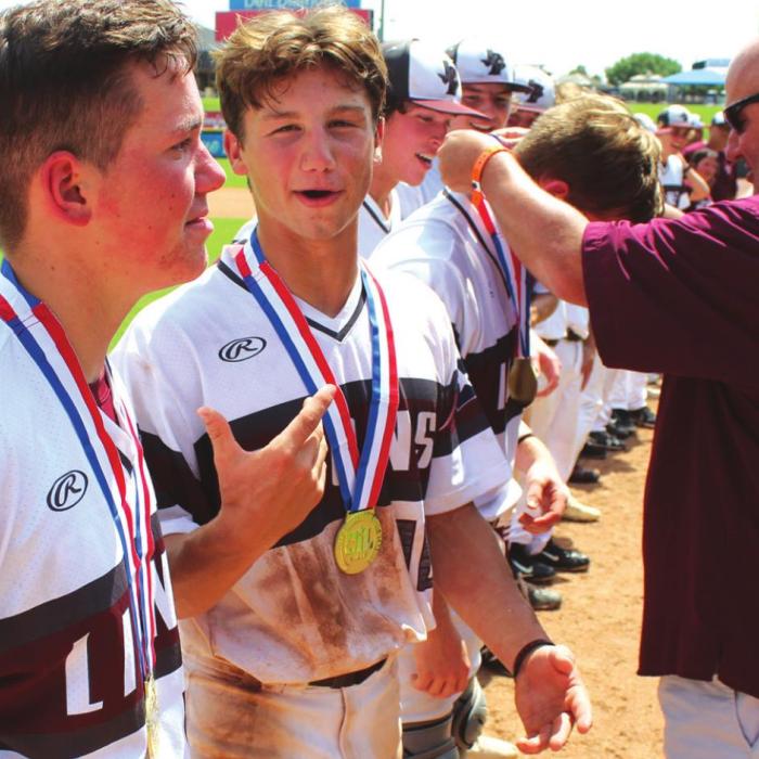 Fayetteville superintendent Dr. Jeff Harvey presents the players with their medals after Thursday’s win in the title game. Photos by Jeff Wick