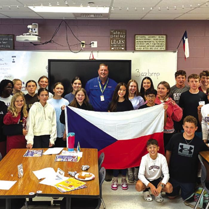 The middle school Leo club members with Texas Czech Heritage and Cultural Center manager Mark Hermes during his visit to the school.