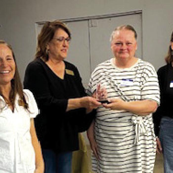 Ystation, owned by Len Peters, was named Business of the Year at the Carmine Chamber of Commerce Mixer on Feb. 27. Pictured accepting the award from Marlene Waak are Melanie Rauch and Amy Nini. Courtney Kieke, Chamber president, is also pictured on the left.