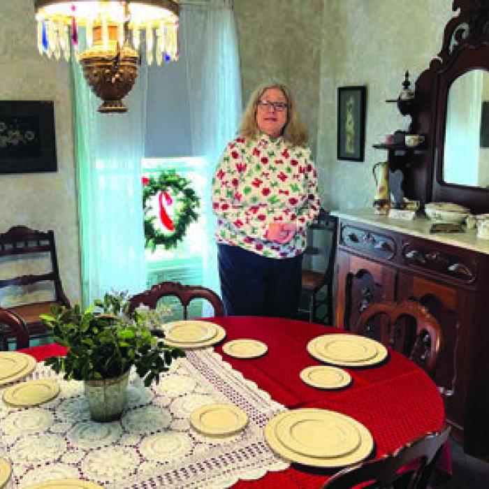 The La Grange Faison House’s Holiday Open House was held Saturday at the home at 822 South Jefferson St. One of the town’s oldest structures, it’s on the National Register of Historic Places. Above, left, Santa and Mrs. Claus greeted visitors on the porch. Above, left, volunteer Katy Beauford stands in the ornate dining room of the home. Photos by Jeff Wick