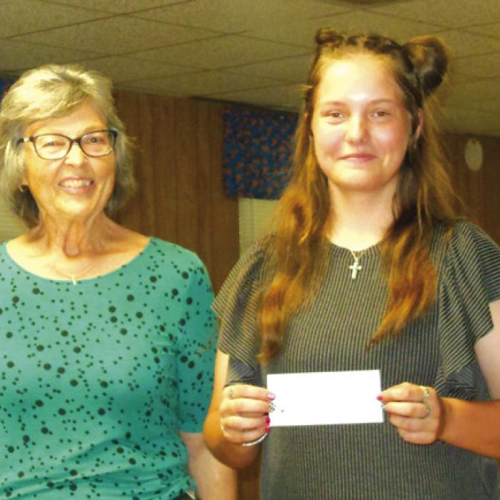 Round Top Hermann Sons Life Lodge 151 President, Linda Mattocks, presenting a check to 2023 scholarship recipient, McKinley Jasinski.