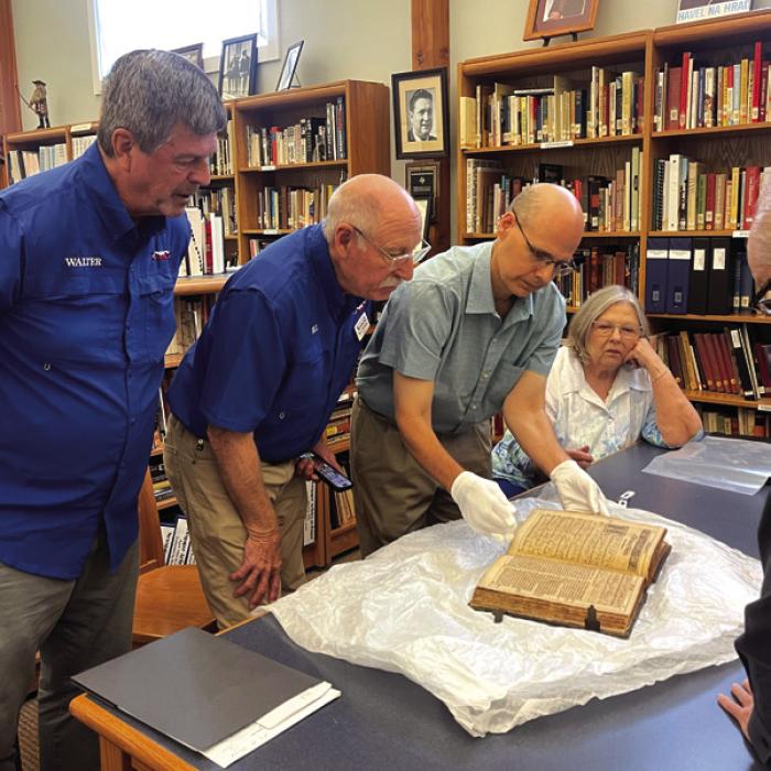 Czech Center staffers examining the 1615 Hymnal.