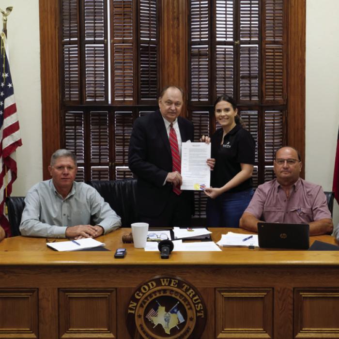 Pictured are (from left) Pct. 4 Commissioner Drew Brossmann, Pct. 3 Commissioner Harvey Berckenhoff, County Judge Dan Mueller, Destiny Siptak, Pct. 2 Commissioner Luke Sternadel, and Pct. 1 Commissioner Jason McBroom. Photo by Andy Behlen