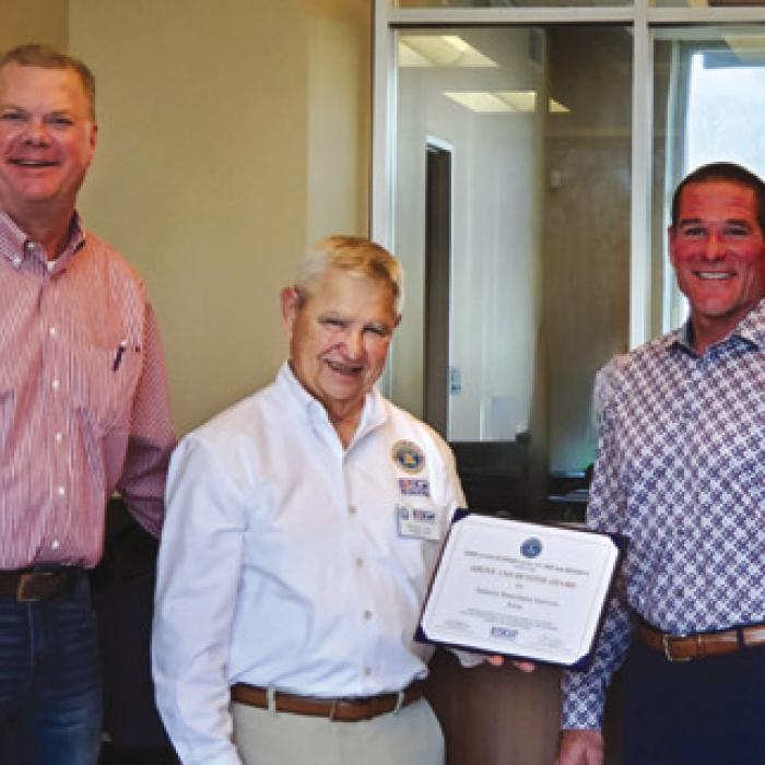 George Nami, Ombudsman Director of ESGR presenting award to President of FNB Bellville, Mike Mueller and CEO of Industry Bancshares, INC. Brian Hobart.