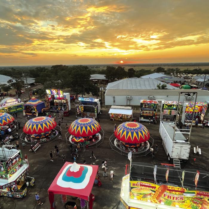 In this view from the top of the Ferris Wheel Thursday night, the sun sets over the Colorado River Valley on the first night of The Fayette County Fair in La Grange. Photo by Jeff Wick 