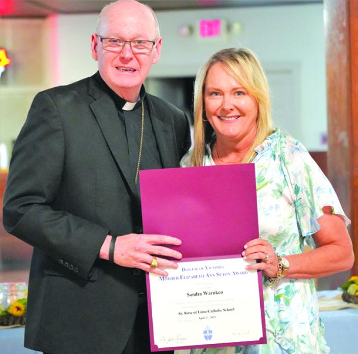 Pictured is Bishop Brendan Cahill presenting the award to Sandra Warnken.