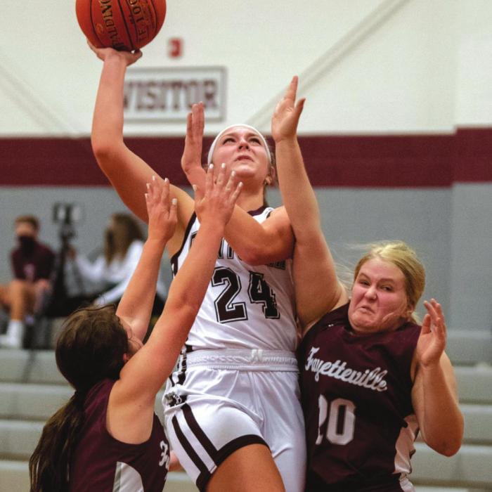 Flatonia’s Caitlin Betak goes up for a shot surrounded by Lady Lion defense, including Mattie Konvicka, right. Photo by Stephanie Steinhauser